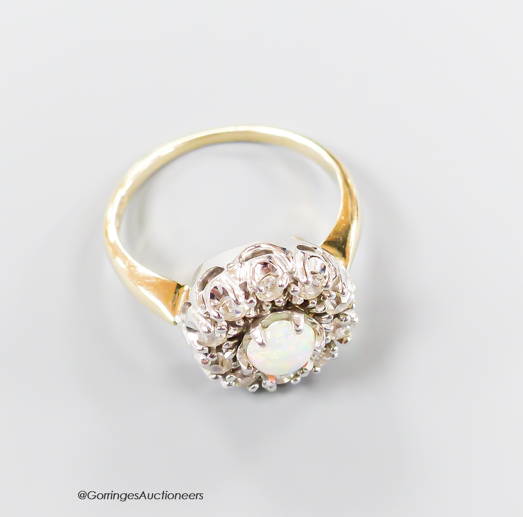 A modern 14k, white opal and illusion set diamond circular cluster ring, size L, gross 4.7 grams.